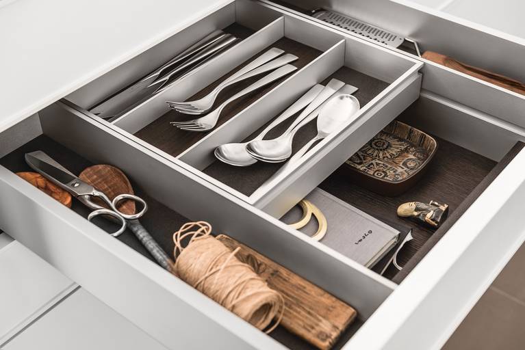 A bi-level drawer elegantly doubles storage space in SieMatic kitchen drawers and pull-outs